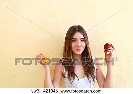 Portrait of beautiful brunette woman holding a red apple View Large Photo Image Stock Photography - Portrait of beautiful brunette woman holding a red apple. Fotosearch