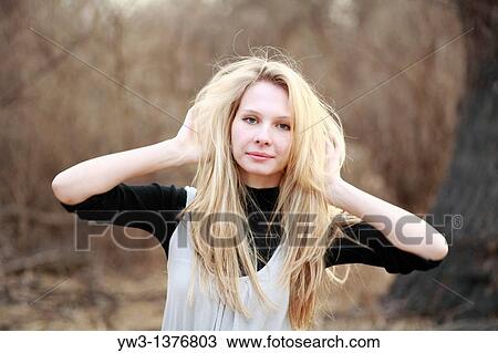 Stock Image - Portrait of beautiful woman in autumn outdoors. Fotosearch