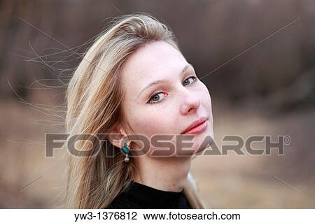Stock Image - Portrait of beautiful woman in autumn outdoors. Fotosearch