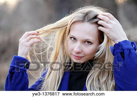 Portrait of beautiful woman in autumn in blue coat View Large Photo Image Stock Photo - Portrait of beautiful woman in autumn in blue coat. Fotosearch