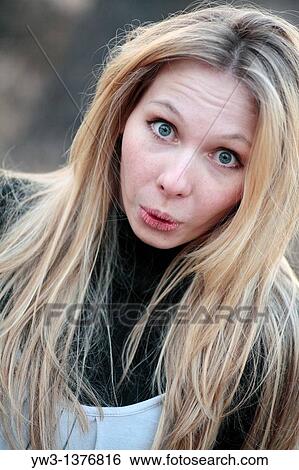 Stock Photograph - Portrait of beautiful woman in autumn outdoors. Fotosearch