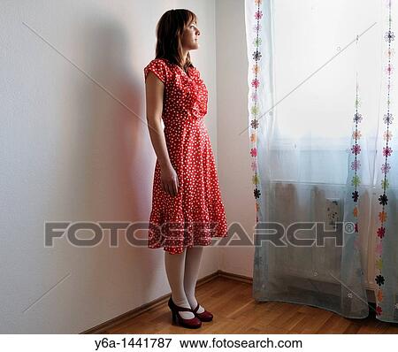 Stock Photo - Portrait of beautiful young woman wearing polka dot dress. Fotosearch