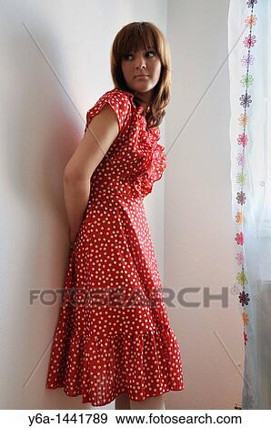Stock Photo - Portrait of beautiful young woman wearing polka dot dress. Fotosearch