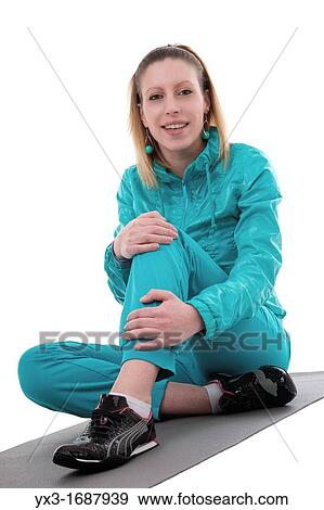 Portrait of beautiful young woman relaxing after fitness, isolated on white View Large Photo Image Stock Photo - Portrait of beautiful young woman relaxing after fitness, isolated on white. Fotosearch