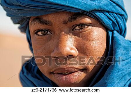 Stock Photograph - Portrait of Berber boy in Tinfou dunes near Tamegrout, Zagora, Draa Valley, Morocco.. Fotosearch