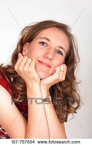 Portrait of blond woman, wearing casual clothing, resting chin in hands, laughing, smiling View Large Photo Image Picture - Portrait of blond woman, wearing casual clothing, resting chin in hands, laughing, smiling. Fotosearch
