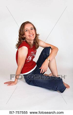Portrait of blond woman, wearing casual clothing, sitting on floor, barefoot, laughing, smiling View Large Photo Image Stock Photography - Portrait of blond woman, wearing casual clothing, sitting on floor, barefoot, laughing, smiling. Fotosearch