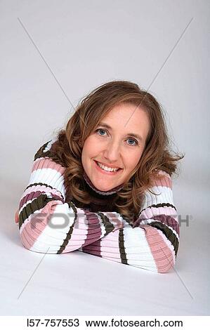 Portrait of blond woman, wearing striped turtlneck sweater, lying on her tummy, arms crossed, laughing, smiling View Large Photo Image Stock Image - Portrait of blond woman, wearing striped turtlneck sweater, lying on her tummy, arms crossed, laughing, smiling. Fotosearch