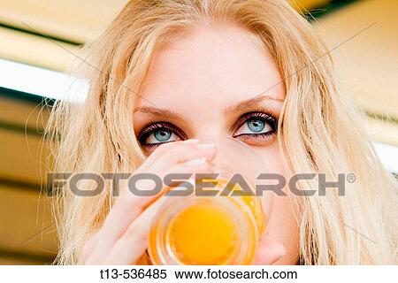 Portrait of blonde girl drinking juice View Large Photo Image Stock Photography - Portrait of blonde girl drinking juice. Fotosearch