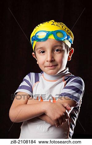 Picture - Portrait of boy(7-8) in a swimming costume.. Fotosearch