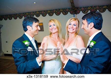 Stock Photo - Portrait of bride and groom facing a mirror. Fotosearch