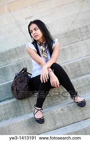 Portrait of brunette The girl on the stairs View Large Photo Image Stock Image - Portrait of brunette The girl on the stairs. Fotosearch