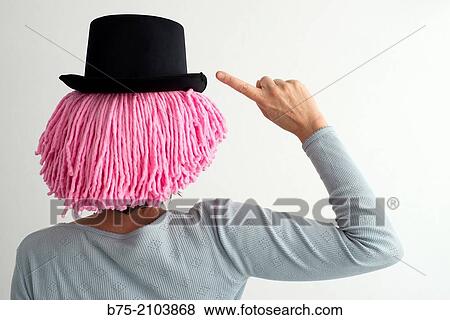 Portrait of Caucasian backs, fifties, pink wig and black hat, making a warning symbol. View Large Photo Image Stock Photo - Portrait of Caucasian backs, fifties, pink wig and black hat, making a warning symbol.. Fotosearch
