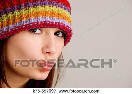Stock Photo - Portrait of caucasian-hispanic woman in her twenties with cap.. Fotosearch