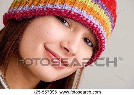 Stock Photography - Portrait of caucasian-hispanic woman in her twenties with cap.. Fotosearch