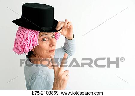 Portrait of Caucasian woman, fifties, pink wig and black hat, making the symbol of victory. View Large Photo Image Stock Photo - Portrait of Caucasian woman, fifties, pink wig and black hat, making the symbol of victory.. Fotosearch