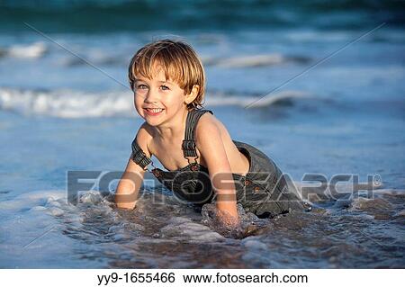 Portrait of Child Playing in the water at the beach - Pompano Beach, Florida USA View Large Photo Image Stock Photograph - Portrait of Child Playing in the water at the beach - Pompano Beach, Florida USA. Fotosearch