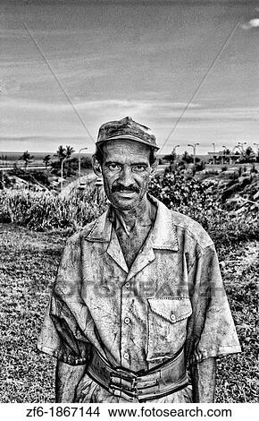 Portrait of common garden worker in city of Havana Cuba dressed in yellow View Large Photo Image Picture - Portrait of common garden worker in city of Havana Cuba dressed in yellow. Fotosearch