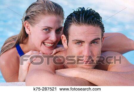 Stock Image - portrait of couple poolside. Fotosearch