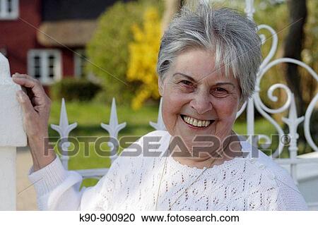 Portrait of elderly caucasian woman at sunny weather smiling and looking into the camera, Island of Amrum, Northfrisian, Schleswig_Holstein, Northern Germany, Europe View Large Photo Image Stock Image - Portrait of elderly caucasian woman at sunny weather smiling and looking into the camera, Island of Amrum, Northfrisian, Schleswig_Holstein, Northern Germany, Europe. Fotosearch