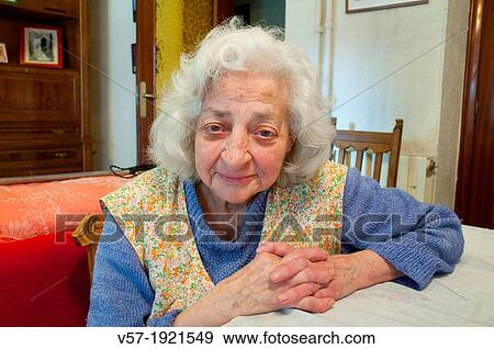 Portrait of elderly woman at home, smiling and looking at the camera View Large Photo Image Stock Photo - Portrait of elderly woman at home, smiling and looking at the camera. Fotosearch