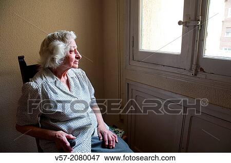 Portrait of elderly woman at home, sitting by the window. View Large Photo Image Stock Photo - Portrait of elderly woman at home, sitting by the window.. Fotosearch