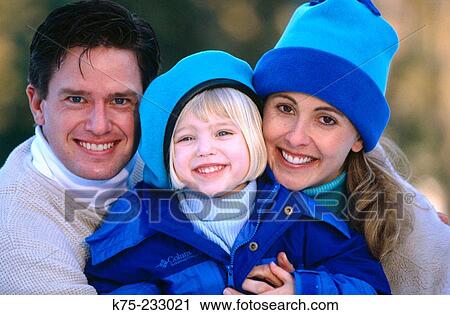 Stock Image - Portrait of family of three in winter. Fotosearch