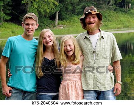 Portrait of father and children outdoors View Large Photo Image Picture - Portrait of father and children outdoors. Fotosearch