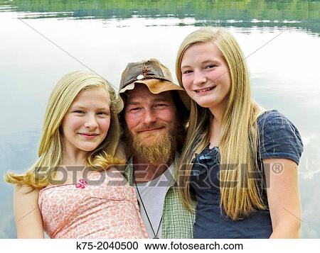 Portrait of father and daughters at lake View Large Photo Image Stock Image - Portrait of father and daughters at lake. Fotosearch
