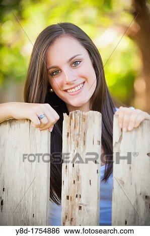 Portrait of female caucasian teenager, 17 years old, behind old wooden fence in Concan, TEXAS, USA View Large Photo Image Stock Photograph - Portrait of female caucasian teenager, 17 years old, behind old wooden fence in Concan, TEXAS, USA. Fotosearch