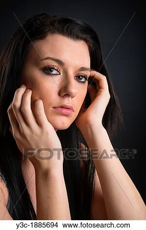 Portrait of female teenager with long black hair on black studio background, 18 years, Caucasian View Large Photo Image Picture - Portrait of female teenager with long black hair on black studio background, 18 years, Caucasian. Fotosearch
