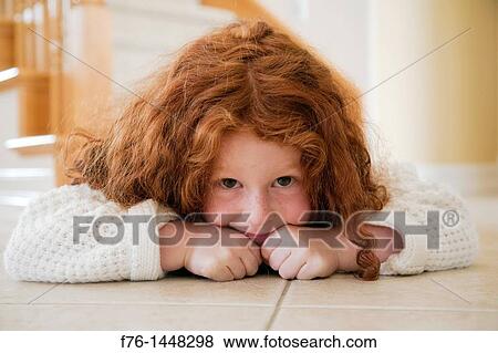 Portrait of five year old girl with red hair lying on tiles on floor View Large Photo Image Stock Photo - Portrait of five year old girl with red hair lying on tiles on floor. Fotosearch