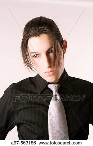 Stock Photograph - Portrait of handsome male teen in black shirt and silver tie.. Fotosearch