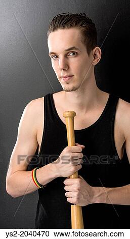 Portrait of handsome young man holding a baseball bat. View Large Photo Image Stock Image - Portrait of handsome young man holding a baseball bat.. Fotosearch