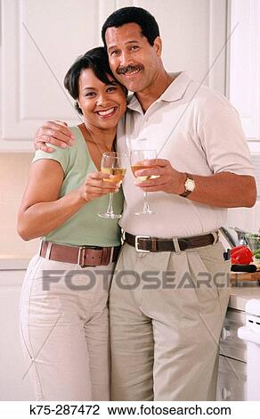 Stock Image - portrait of happy couple in kitchen. Fotosearch
