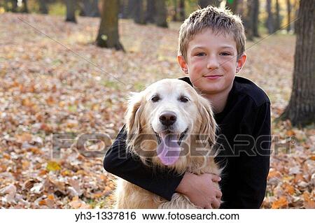 Portrait of happy young boy hugging his golden retriever dog View Large Photo Image Stock Photograph - Portrait of happy young boy hugging his golden retriever dog. Fotosearch