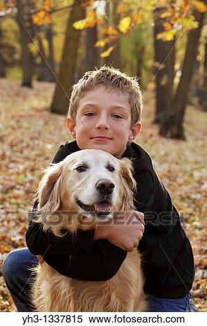 Portrait of happy young boy hugging his golden retriever dog View Large Photo Image Stock Photography - Portrait of happy young boy hugging his golden retriever dog. Fotosearch