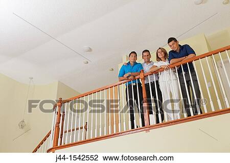 Portrait of Hispanic family standing by railing in house View Large Photo Image Stock Image - Portrait of Hispanic family standing by railing in house. Fotosearch