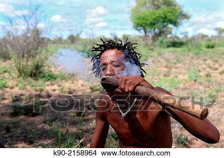 Picture - Portrait of Ju/? hoansi San man smoking his pipe, Tsumkwe, Otjozondjupa Region, Namibia, Africa.. Fotosearch