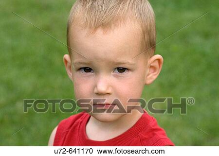 Stock Image - Portrait of Little Boy in Garden. Fotosearch