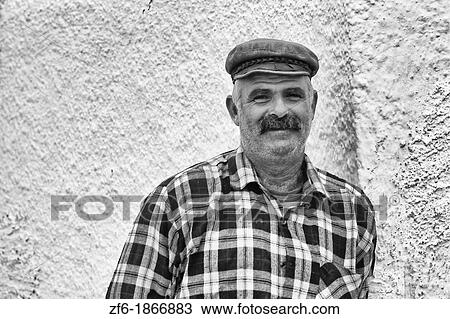 Portrait of Local Man by the White Buildings of Oia Santorini Greece View Large Photo Image Stock Image - Portrait of Local Man by the White Buildings of Oia Santorini Greece. Fotosearch