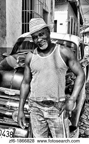 Portrait of local man in front of classic 50s blue Chevy on streets of Trinidad Cuba View Large Photo Image Stock Photo - Portrait of local man in front of classic 50s blue Chevy on streets of Trinidad Cuba. Fotosearch