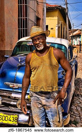 Portrait of local man in front of classic 50s blue Chevy on streets of Trinidad Cuba View Large Photo Image Stock Photography - Portrait of local man in front of classic 50s blue Chevy on streets of Trinidad Cuba. Fotosearch