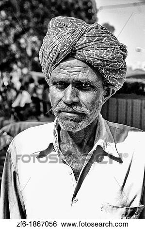 Stock Photograph - Portrait of local man with turban in small village of Shahpura in Rajasthan near Jodhpur India. Fotosearch