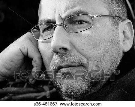 Stock Photo - Portrait of male business man in his forties, wearing glasses. Black and white photo. beard, serious look on his face. Fotosearch