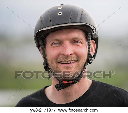 Portrait of man in horseback riding helmet, Iceland. View Large Photo Image Stock Photo - Portrait of man in horseback riding helmet, Iceland.. Fotosearch