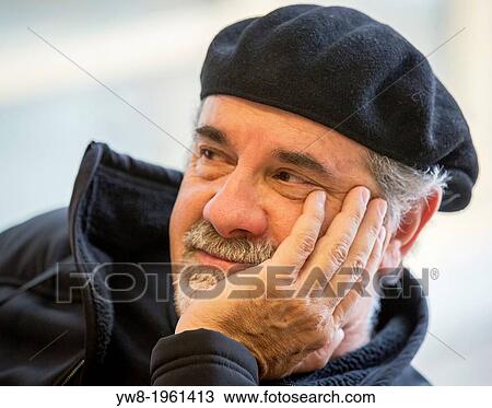 Stock Image - Portrait of man with a hat.. Fotosearch