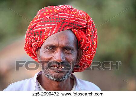 Stock Image - Portrait of man with red turban. Bhil tribe. Madhya Prades, India.. Fotosearch