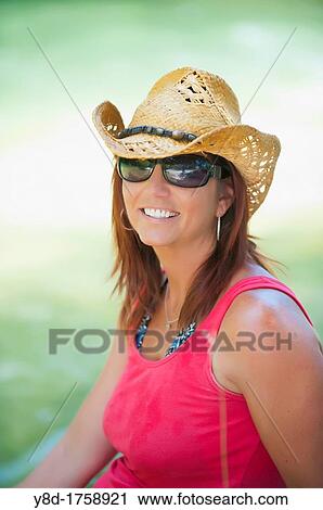 Portrait of mature female, 45 years old caucasian, wearing sunglasses and cowboy hat View Large Photo Image Stock Image - Portrait of mature female, 45 years old caucasian, wearing sunglasses and cowboy hat. Fotosearch