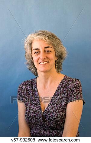 Portrait of mature woman smiling and looking at the camera View Large Photo Image Stock Photo - Portrait of mature woman smiling and looking at the camera. Fotosearch